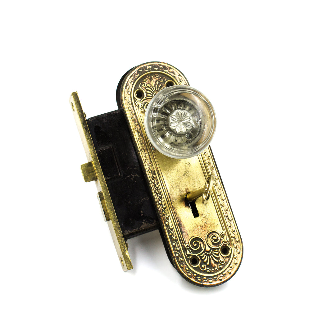 this is a vintage 1920s dexter glass doorknob set with mortise lock and backplates