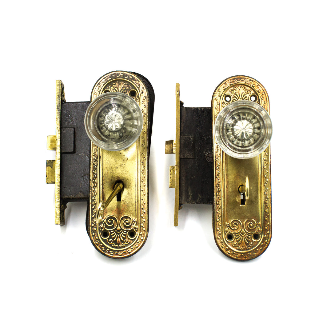 this a pair of two vintage dexter glass door knob sets with mortise locks and backplates