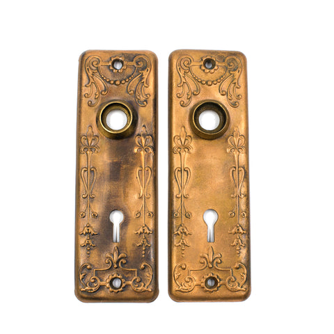 this is a pair of vintage victorian copper floral escutcheons