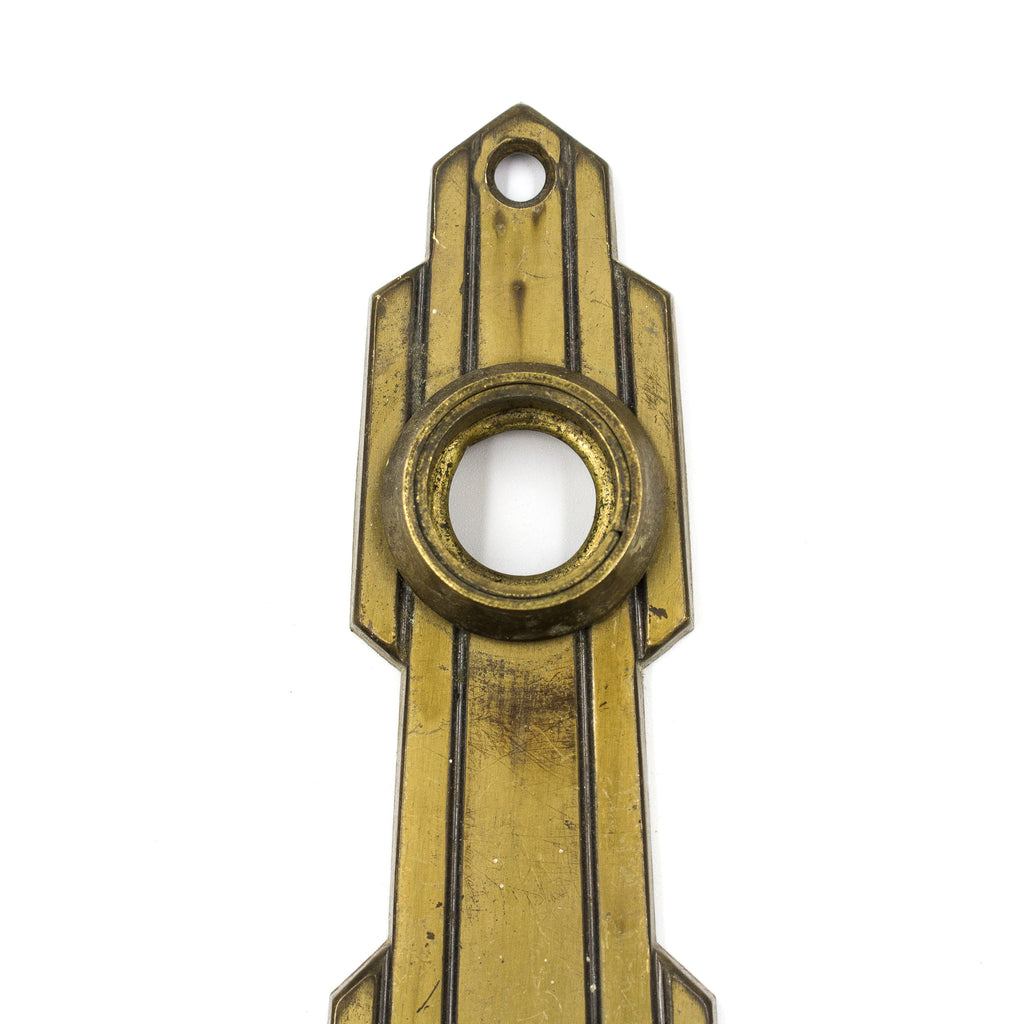 this is a close up picture of the top of a vintage mid century art deco escutcheon showing where the doorknob would go
