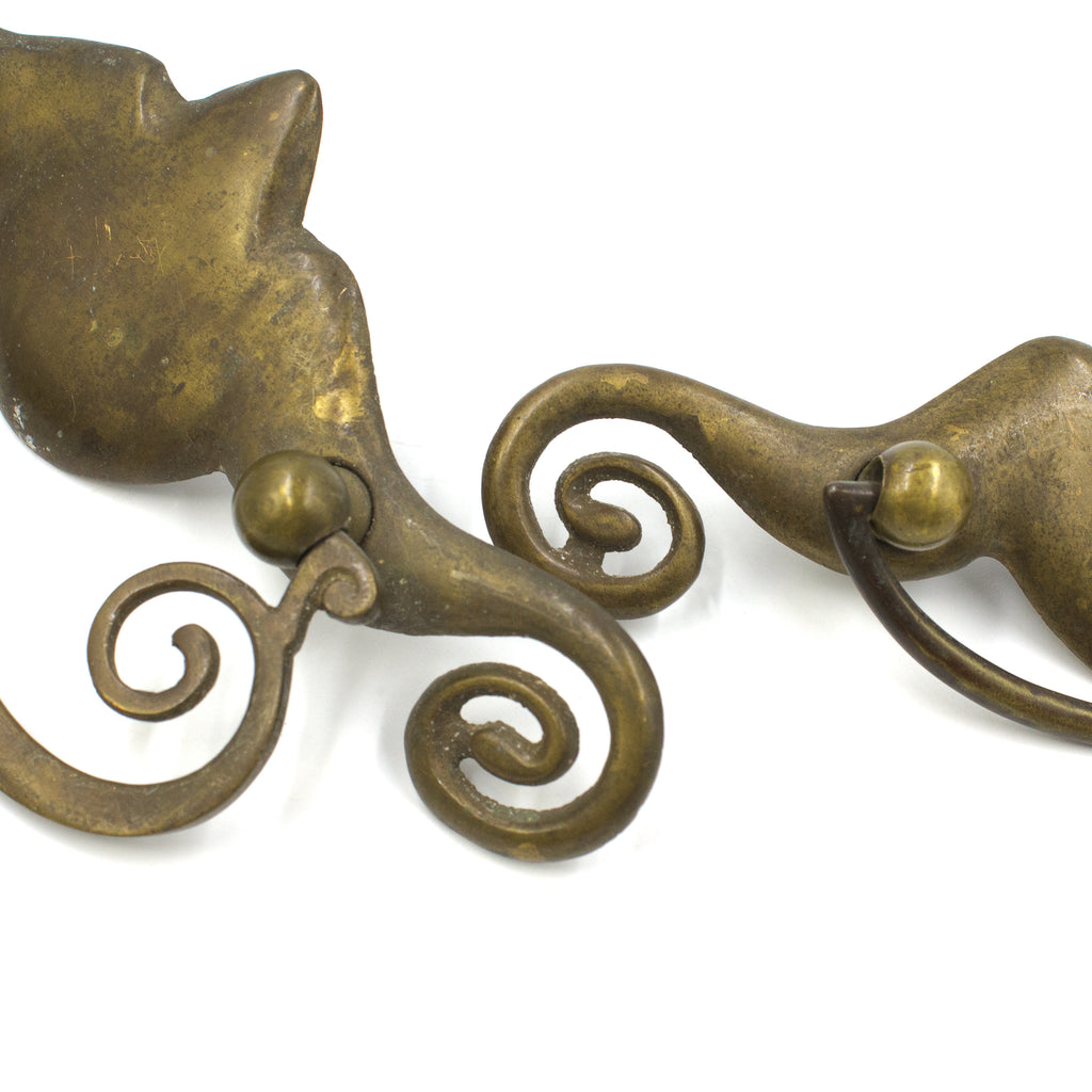 This picture shows the ends of a pair of vintage brass bail pulls
