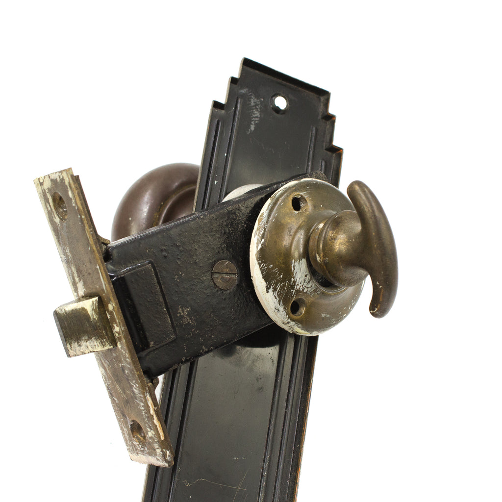 this is a picture of the turn lock on a vintage art deco entry door knob set