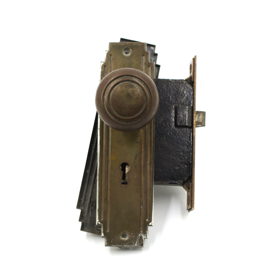 this is a picture of a vintage art deco doorknob set with mortise lock and backplates