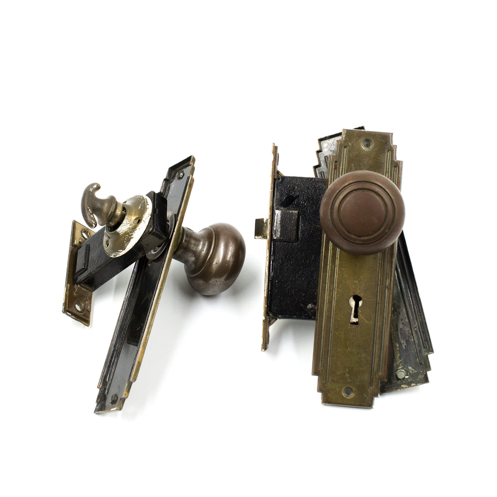 this is a vintage art deco entry door knob set with mortise lock and backplates