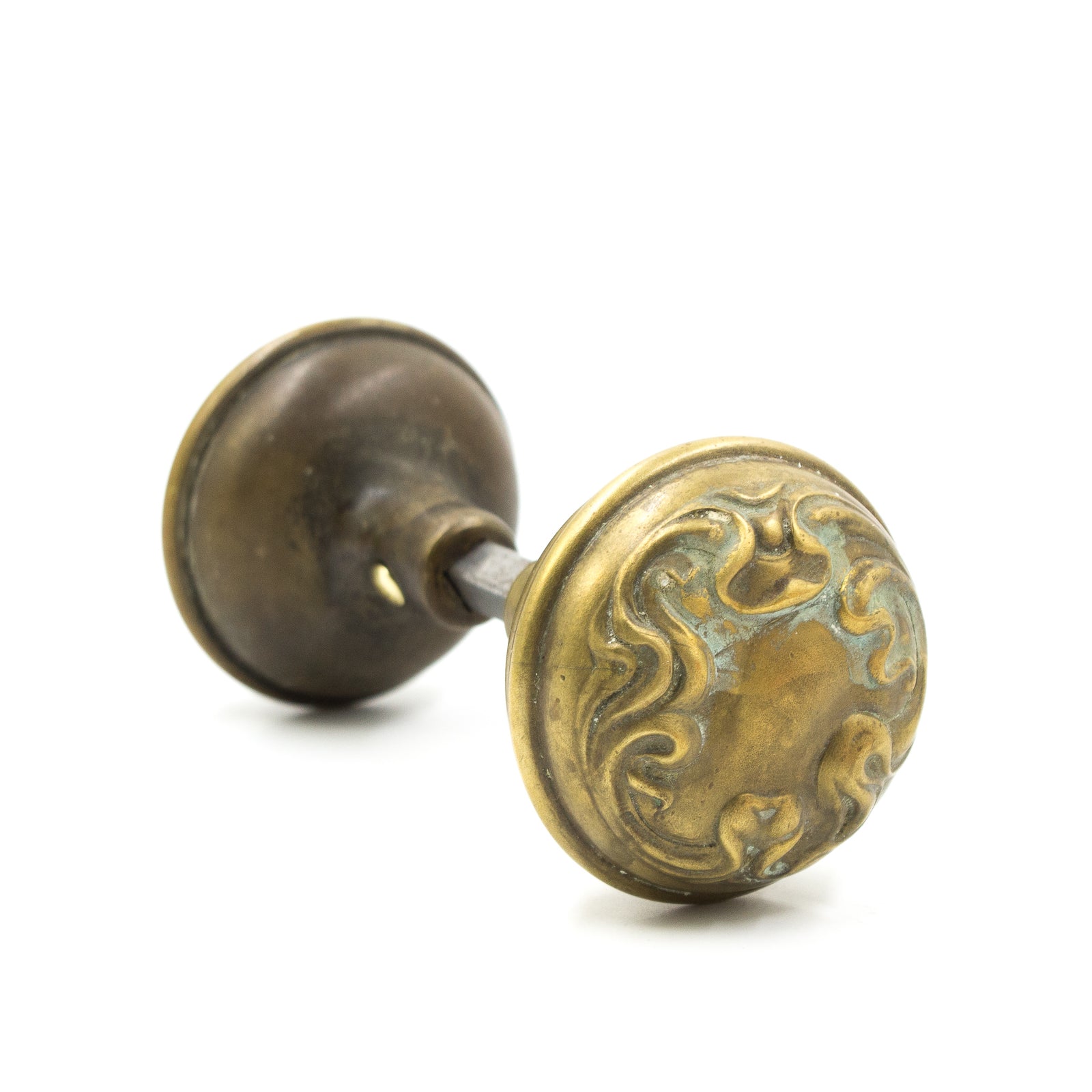 this is an antique brass art nouveau doorknob set