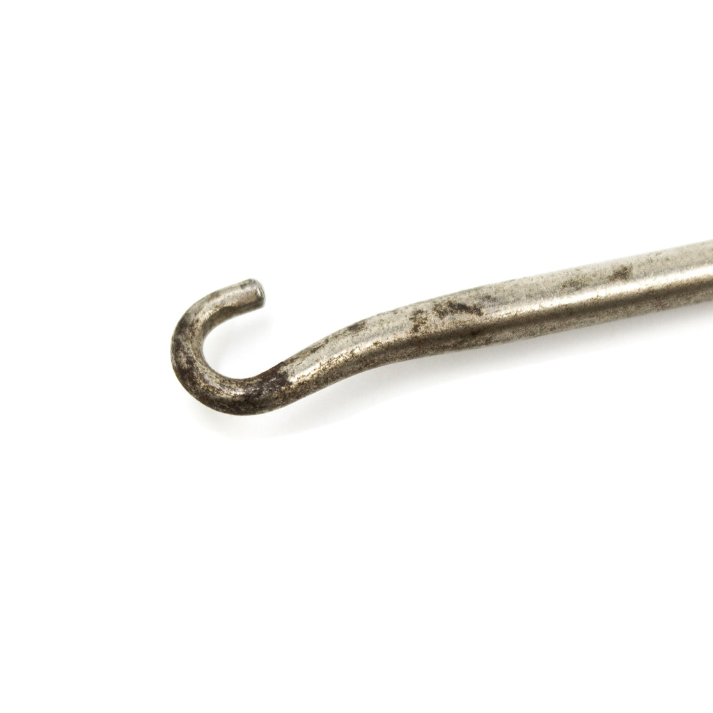 this is a close up picture of the hook of a vintage button hook