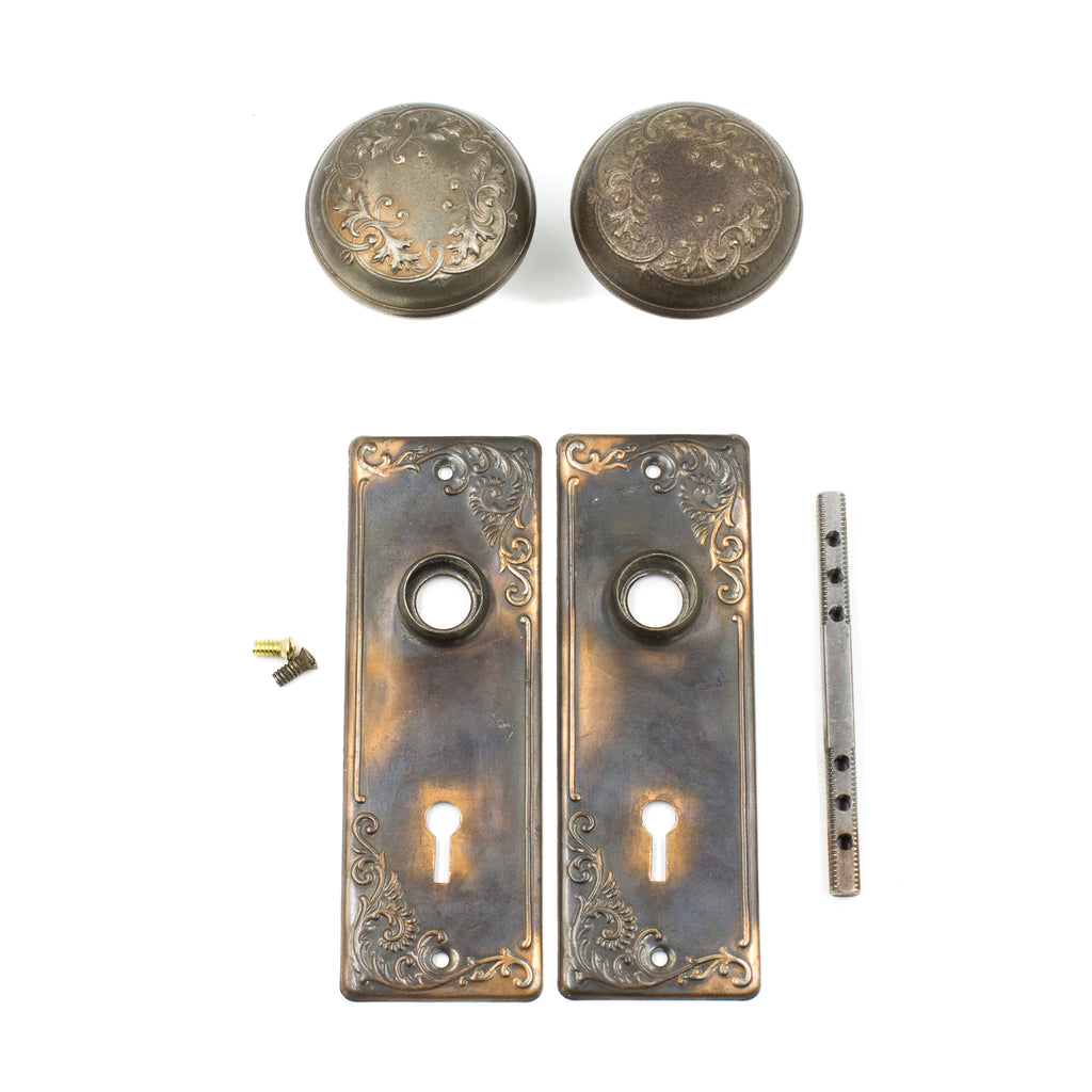 this is a picture of an antique Victorian doorknob set with backplates, a spindle and set screws