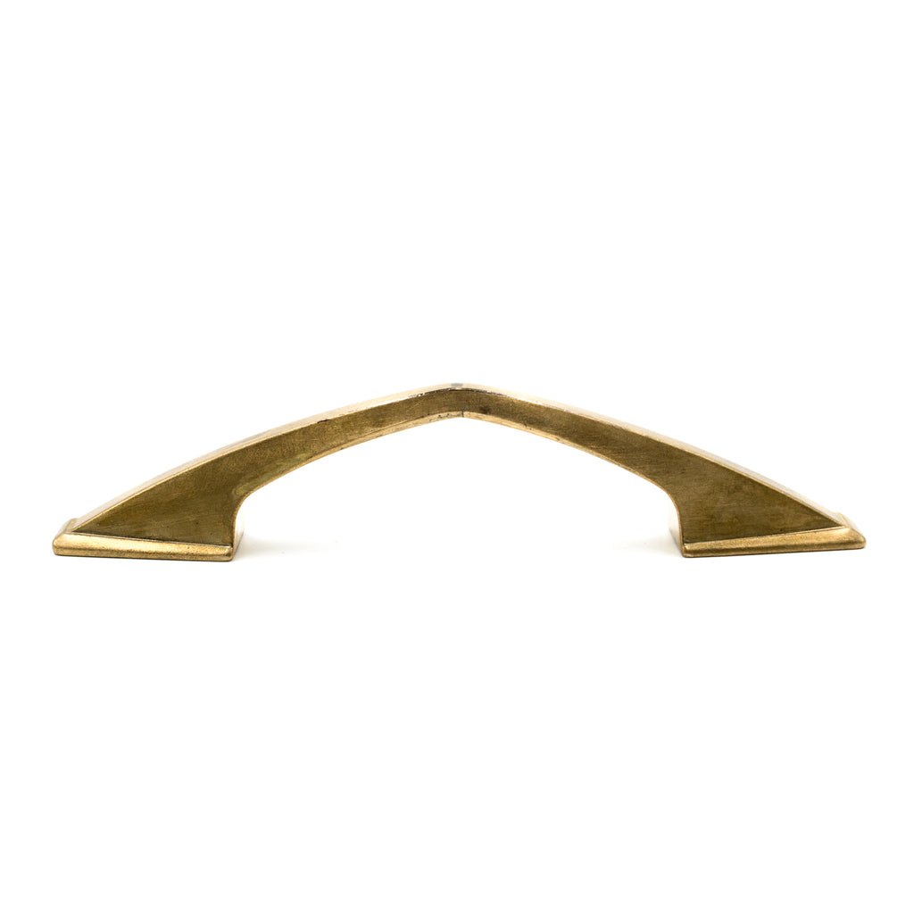 This is a side profile view of a vintage bronze angled cabinet or drawer pull