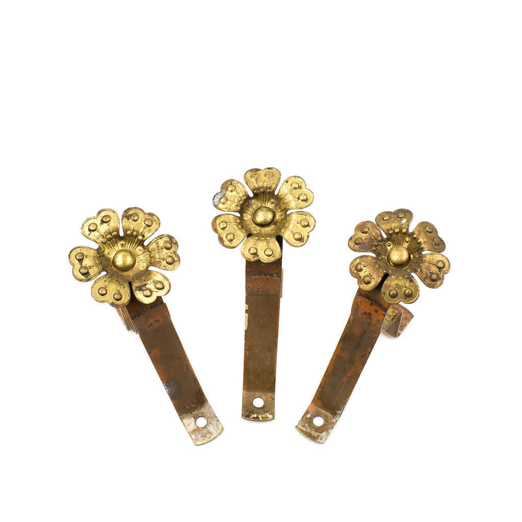 this is a set of 3 vintage brass curtain rod brackets with large flower screws