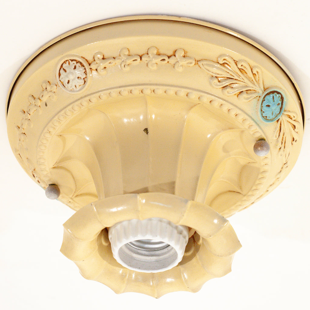 this picture shows the canopy of a vintage bare bulb ceiling fixture