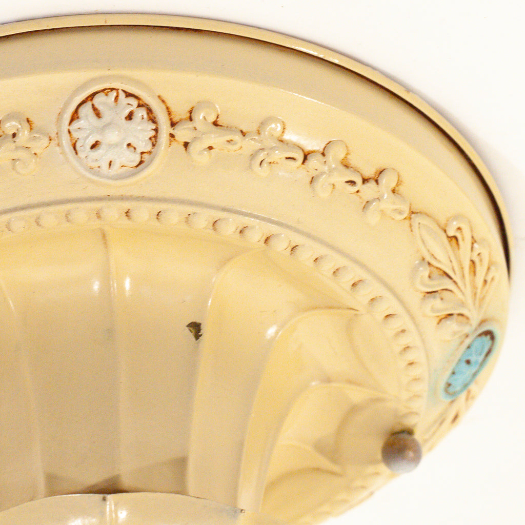 this picture shows the detail, design and small paint chip on a vintage bare bulb ceiling fixture