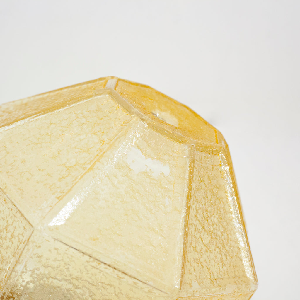 this is an up close picture of some minor wear on a vintage yellow crackle glass shade
