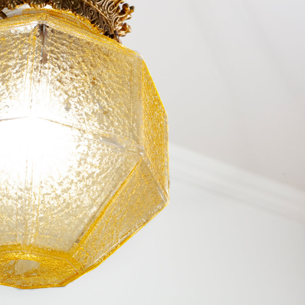 this is a picture of a vintage yellow glass crackle shade that shows the shade lit up and some of the detail