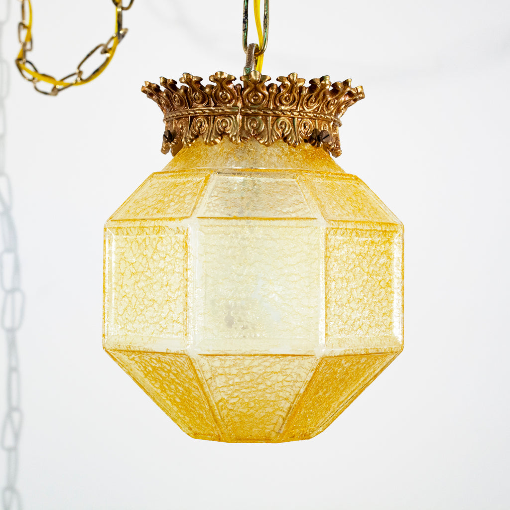 this picture shows a vintage yellow glass crackle shade and canopy swag light fixture. The shade is not lit. 
