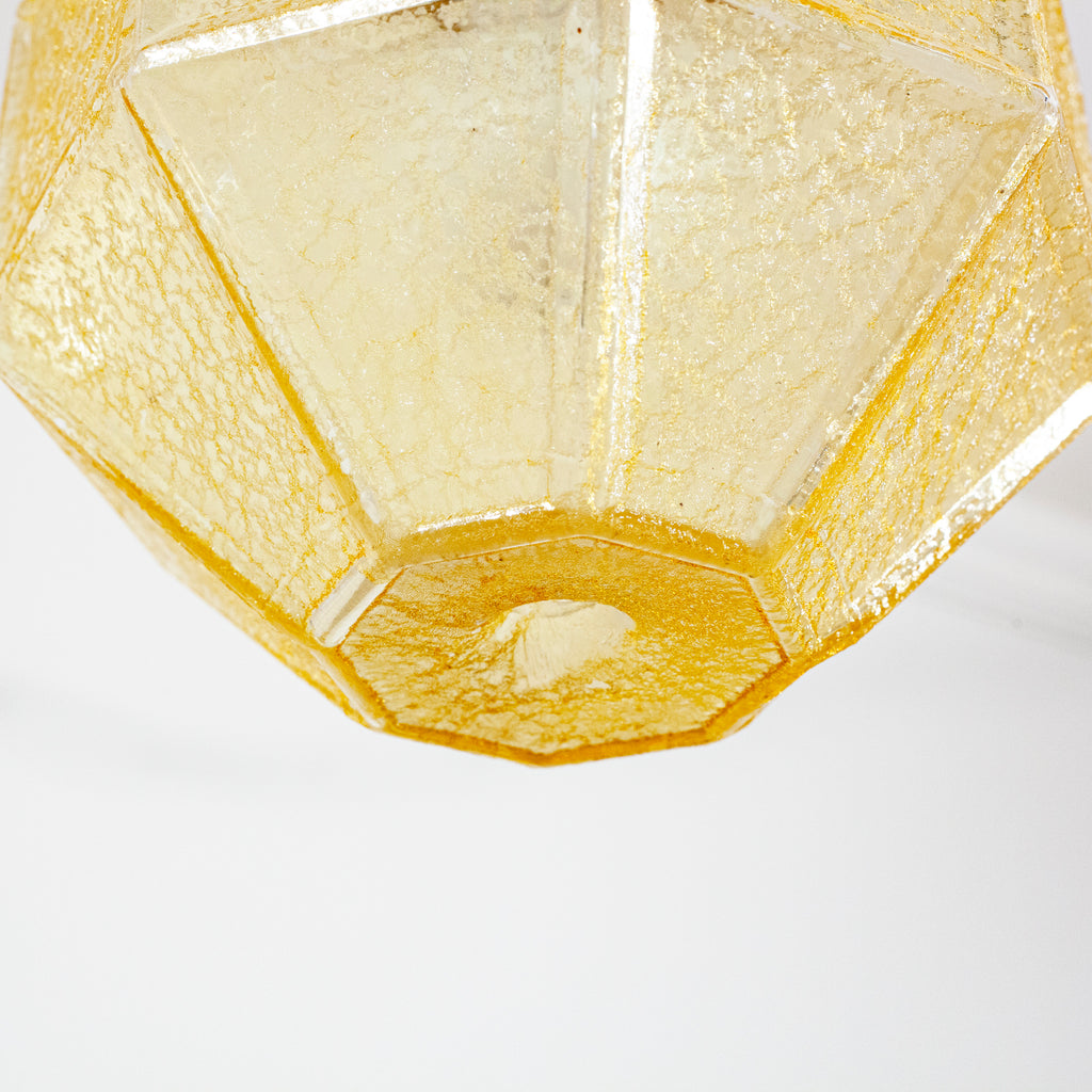 this picture shows the bottom of a vintage yellow glass crackle shade swag light 