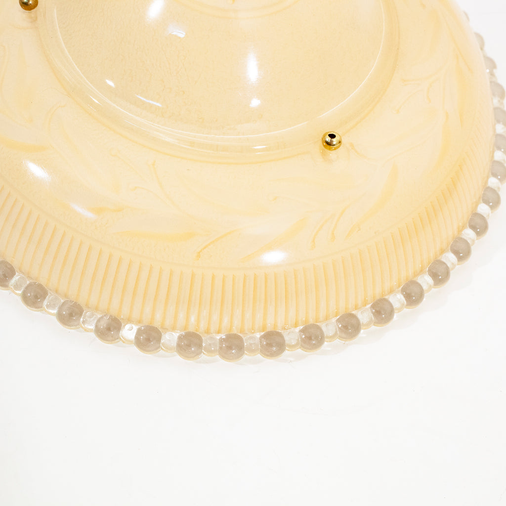 this is detail of a vintage mid century three chain peach colored glass shade with floral detail