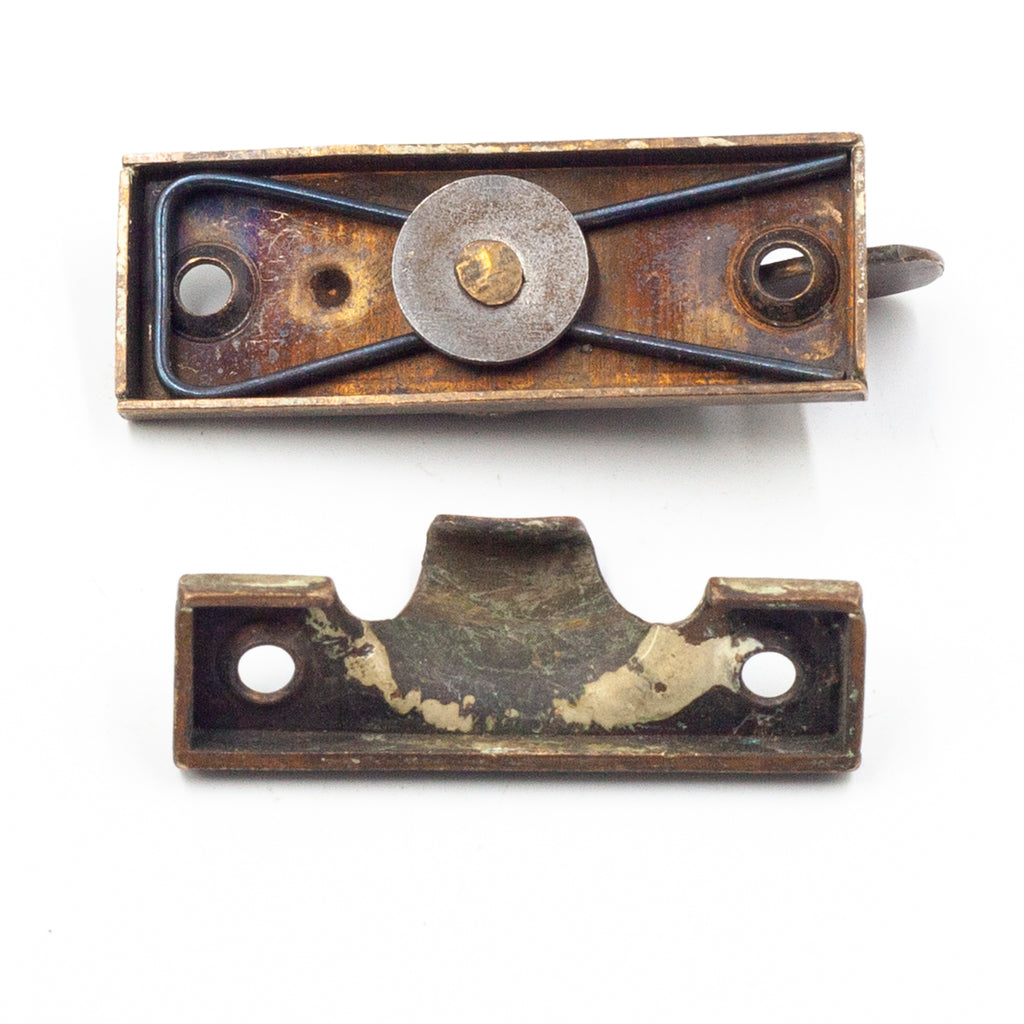 this picture shows the underside of an antique sash lock