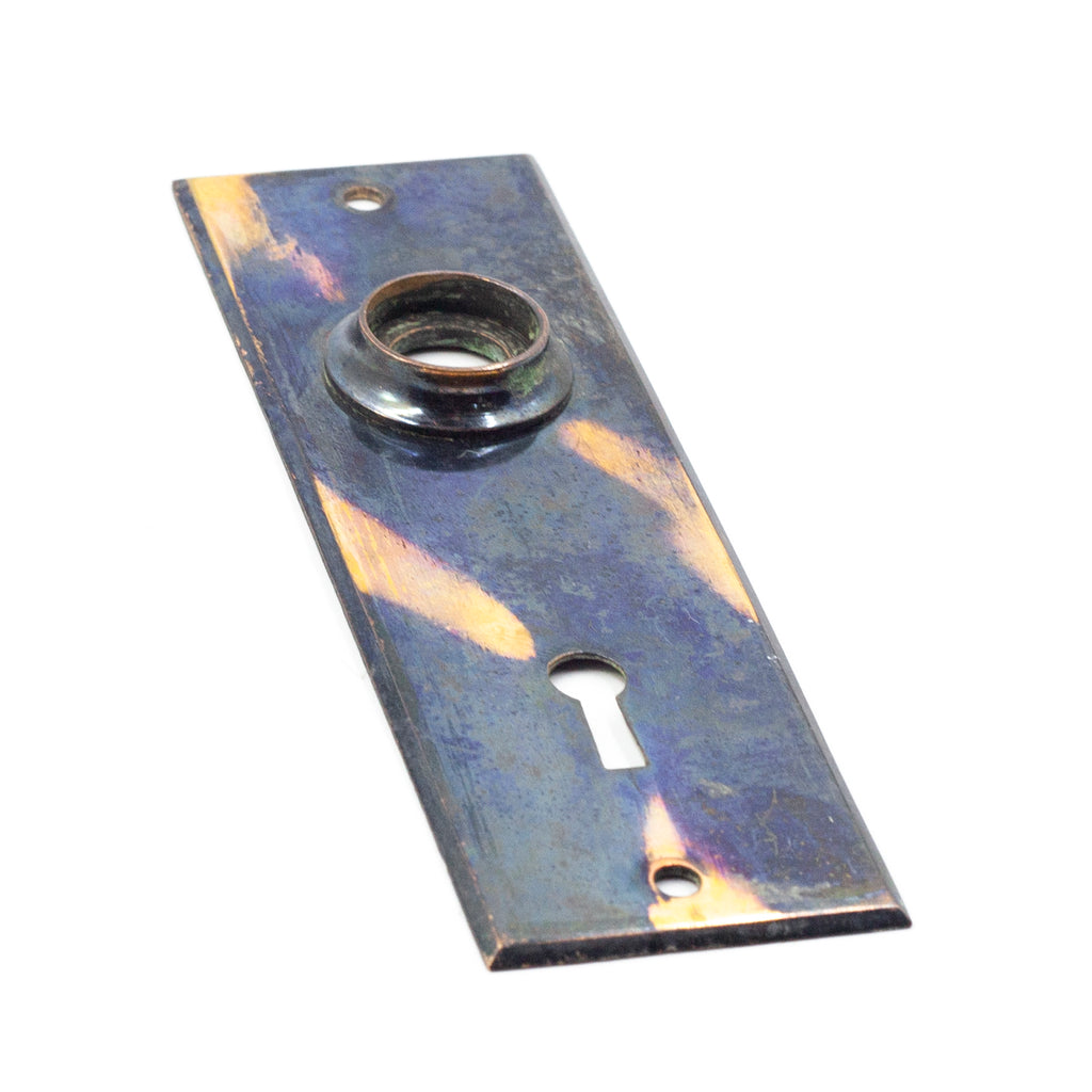 this is a side angle view of a vintage copper flash japanned escutcheon
