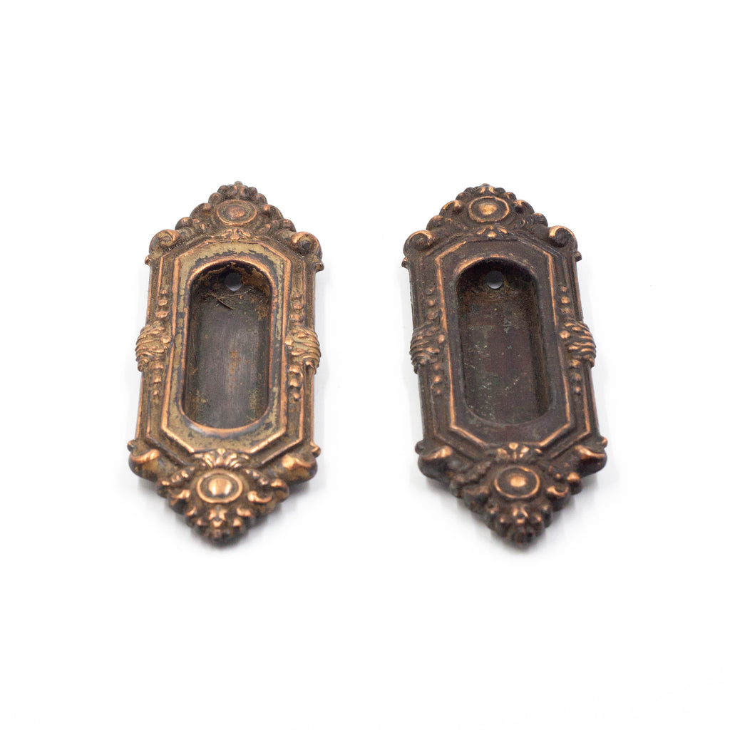 this is a side bottom view of a pair of antique Victorian brass window lifts